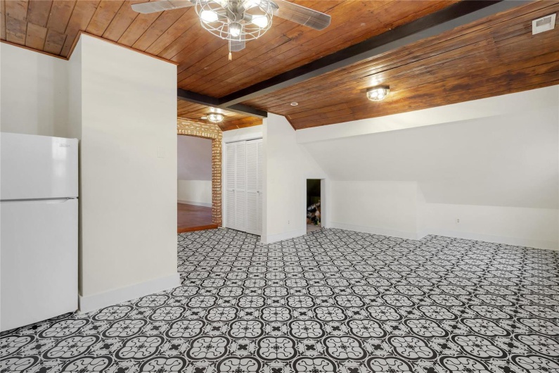 Third floor studio. Bonus room with vaulted ceiling with beams, wooden ceiling, and ceiling fan