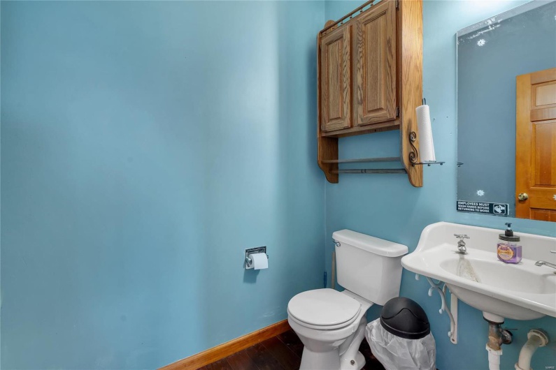 Bathroom with hardwood / wood-style flooring and toilet