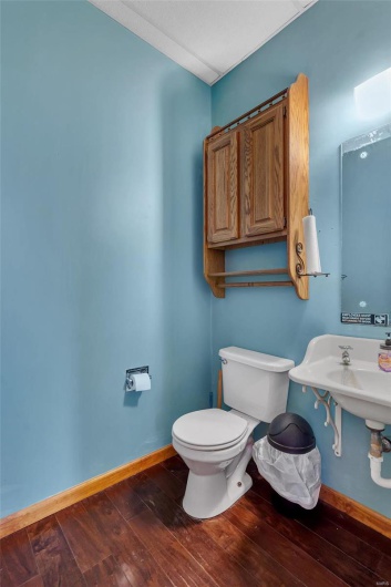 Bathroom with hardwood / wood-style floors and toilet