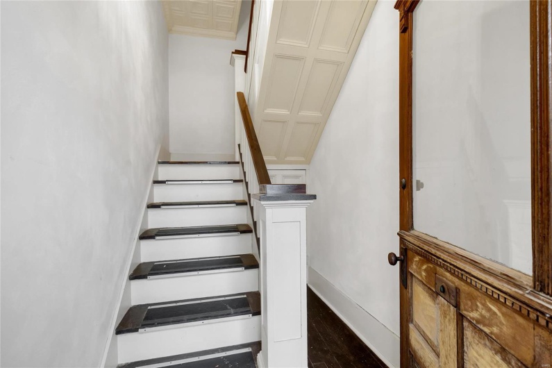Stairway with hardwood / wood-style floors