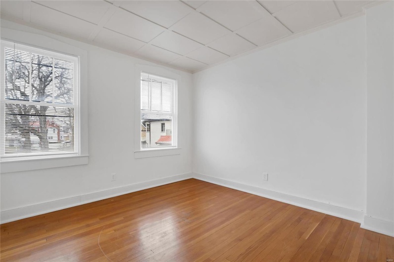 Second floor apartment. Unfurnished room featuring wood-type flooring, plenty of natural light.