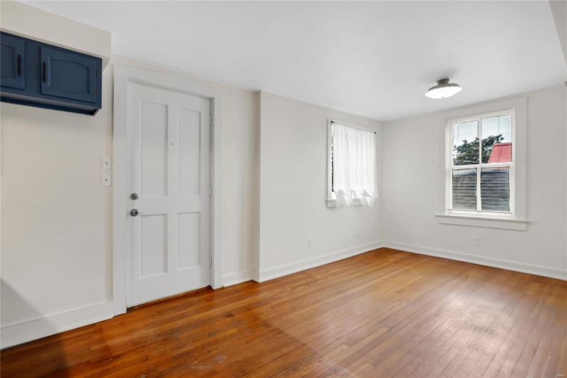 Second floor apartment. Spare room featuring hardwood / wood-style floors