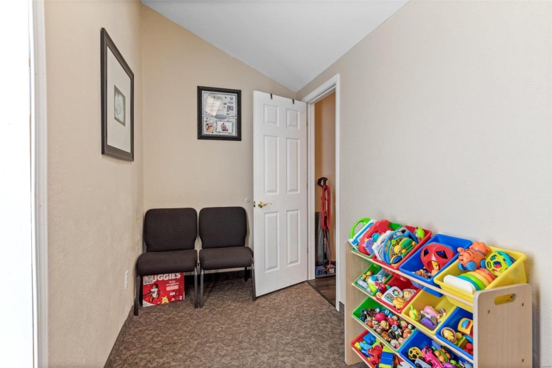 Game room with lofted ceiling and carpet floors