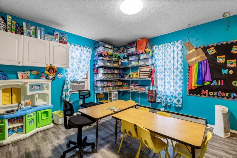 Office space featuring hardwood / wood-style flooring and a textured ceiling