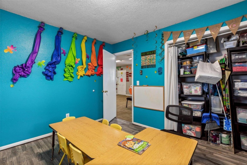 Office area with dark hardwood / wood-style flooring and a textured ceiling