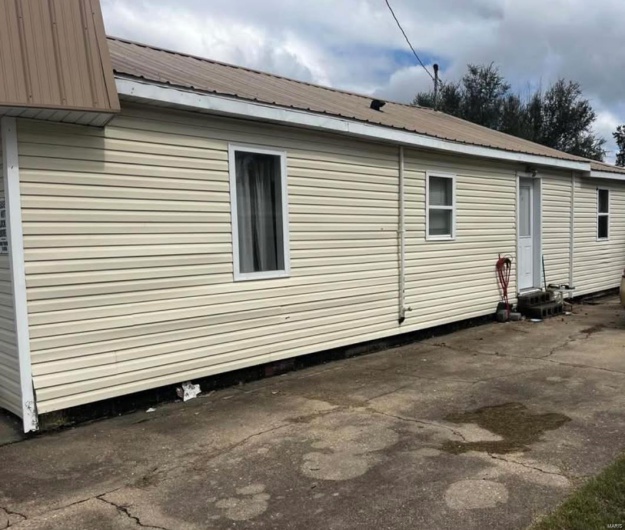 View of side of home featuring a patio