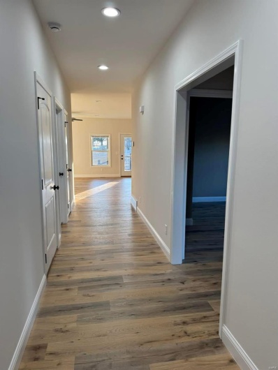 Corridor featuring dark hardwood / wood-style flooring