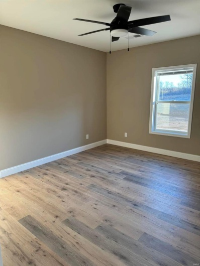 Empty room featuring ceiling fan and light hardwood / wood-style floors
