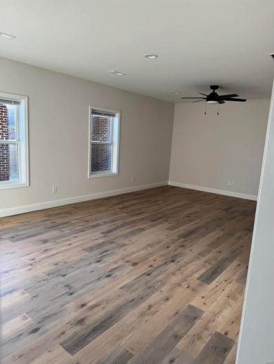 Spare room with hardwood / wood-style flooring and ceiling fan