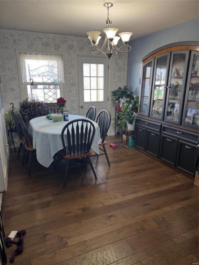 Dining area featuring a chandelier and dark hardwood / wood-style floors