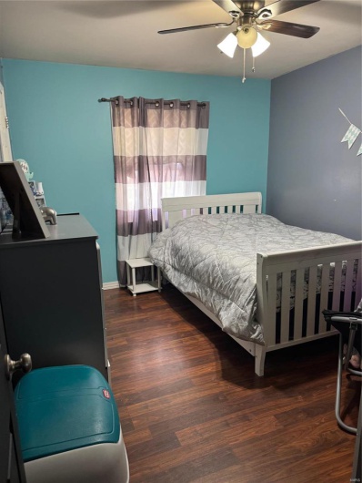 Bedroom featuring dark hardwood / wood-style flooring and ceiling fan