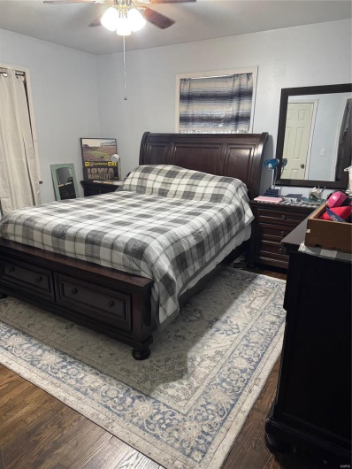 Bedroom with hardwood / wood-style flooring and ceiling fan
