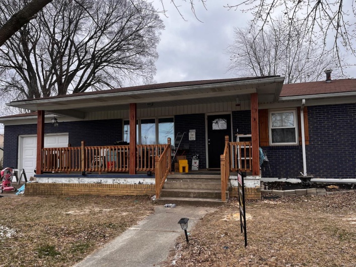 Single story home featuring covered porch