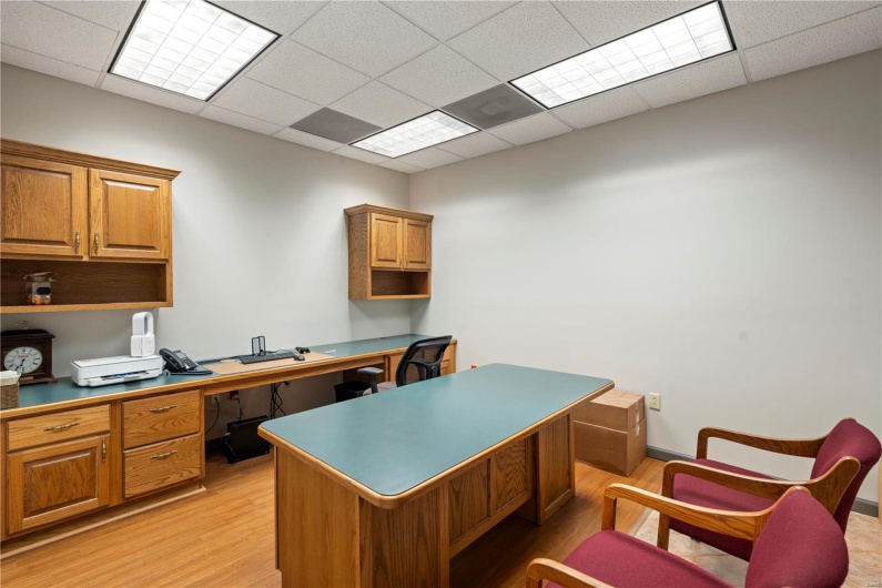 Home office featuring a drop ceiling and light wood-type flooring