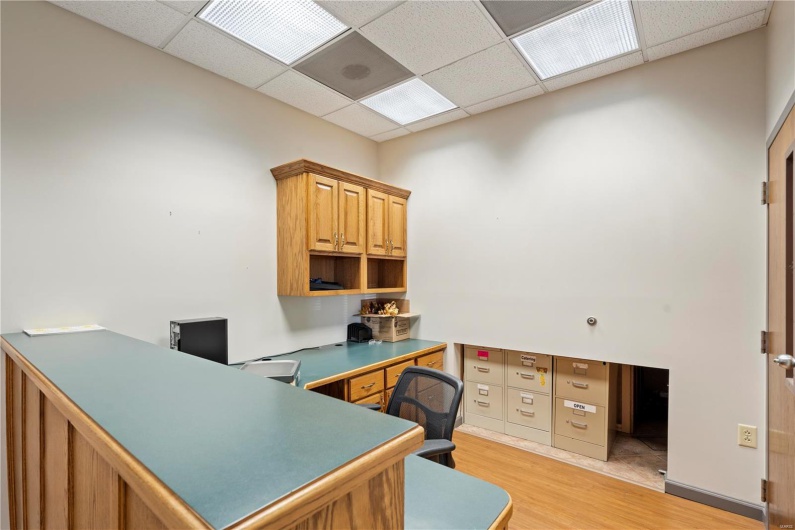 Office featuring light wood-type flooring and a paneled ceiling
