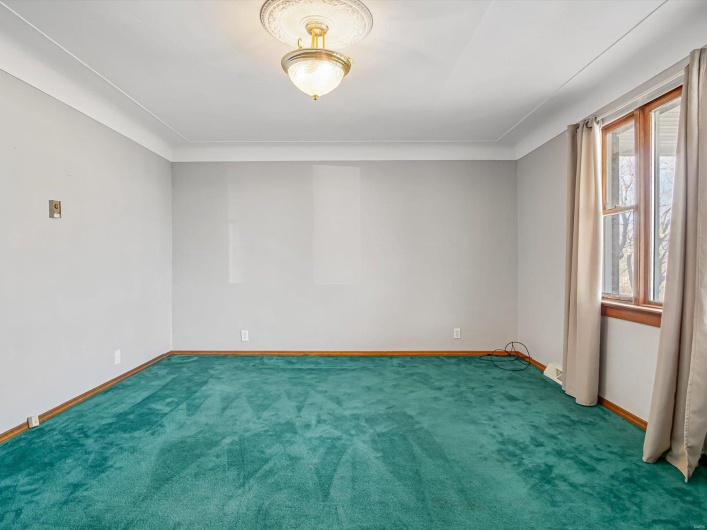 Empty room with carpet and baseboards
