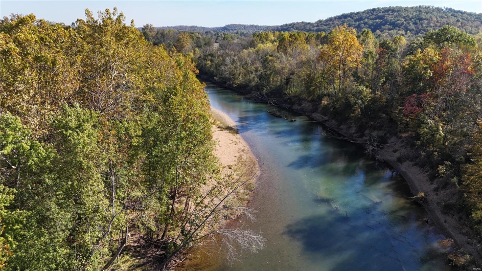 Birds eye view of property with a water view