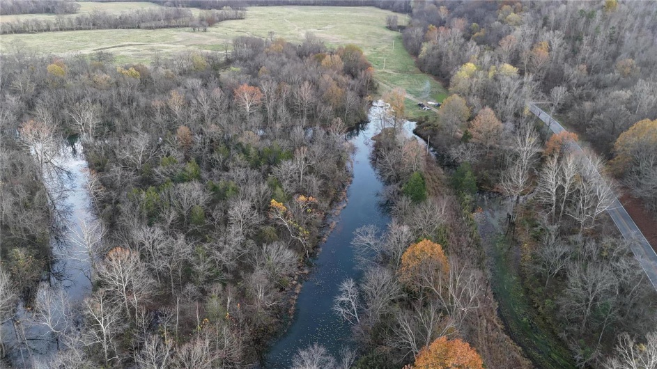 Birds eye view of property with a water view