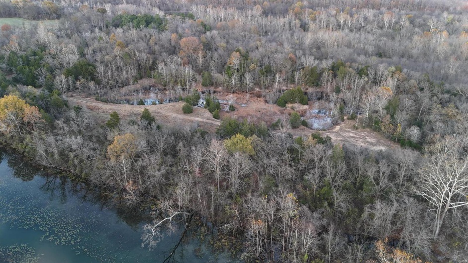 Birds eye view of property with a water view