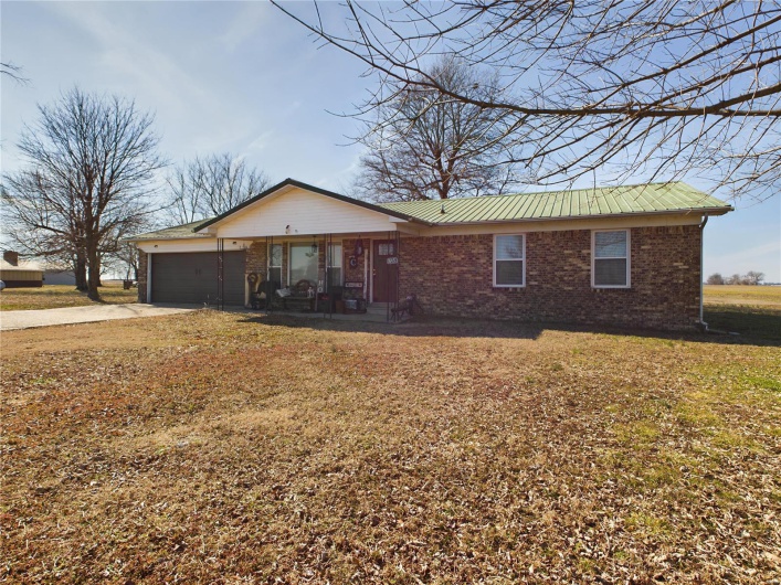 Ranch-style home with a front lawn and a garage