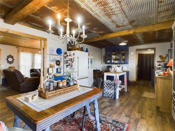 Dining space with beamed ceiling, a chandelier, dark hardwood / wood-style floors, and wooden ceiling