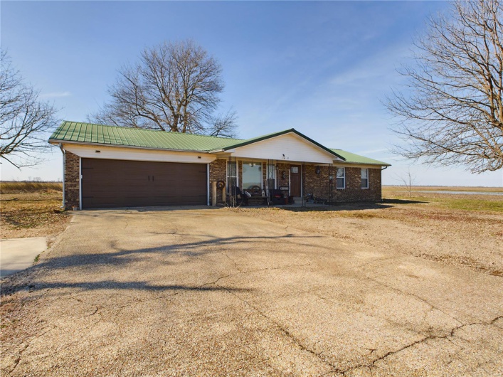 Ranch-style house with covered porch and a garage