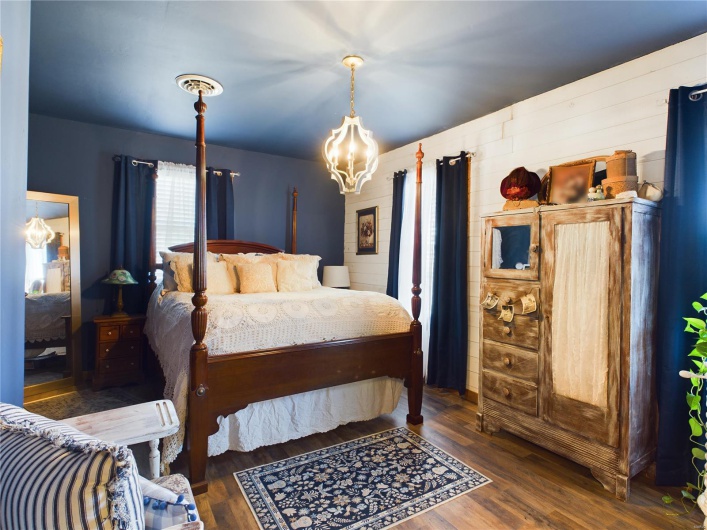 Bedroom featuring a notable chandelier and dark hardwood / wood-style floors