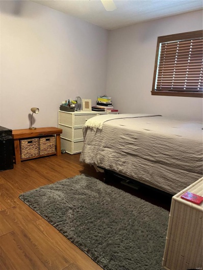 Bedroom with ceiling fan and wood finished floors