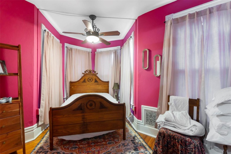 Bedroom with wood flooring and ceiling fan