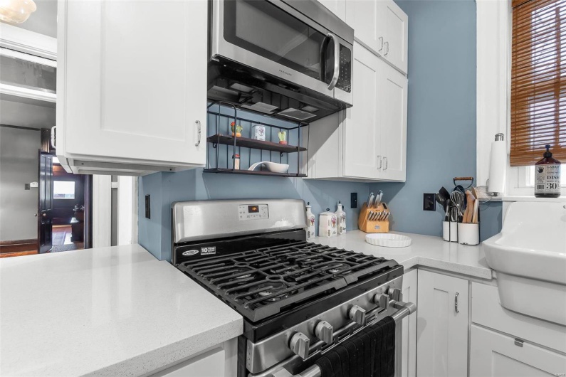 Kitchen with appliances with stainless steel finishes and white cabinets