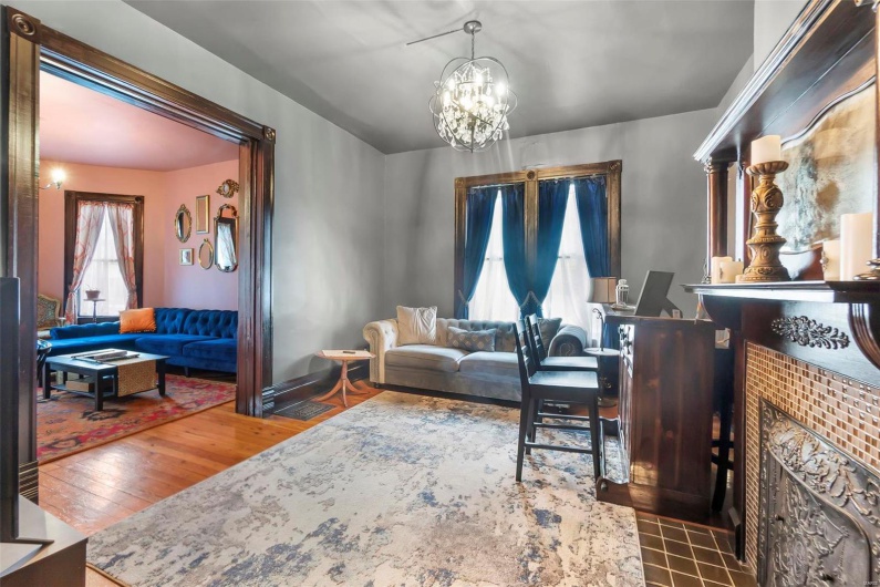 Living room with hardwood flooring and a notable chandelier