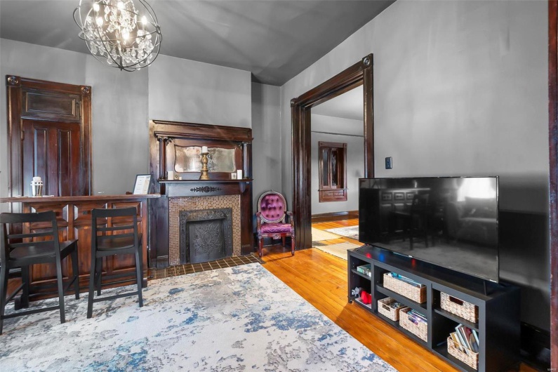 Living room featuring hardwood  flooring and a chandelier