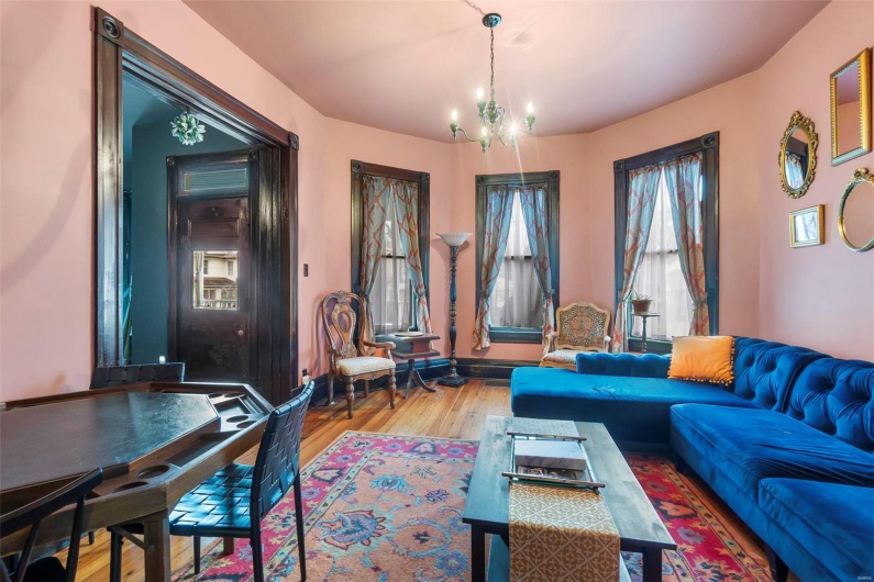 Living room featuring a chandelier and hardwood floors