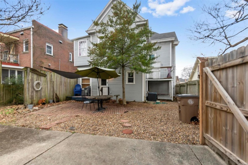 Back of house with central AC unit and a patio area