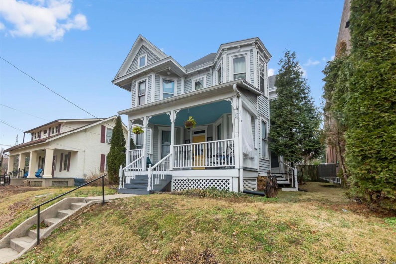 Victorian house with covered porch and a front lawn