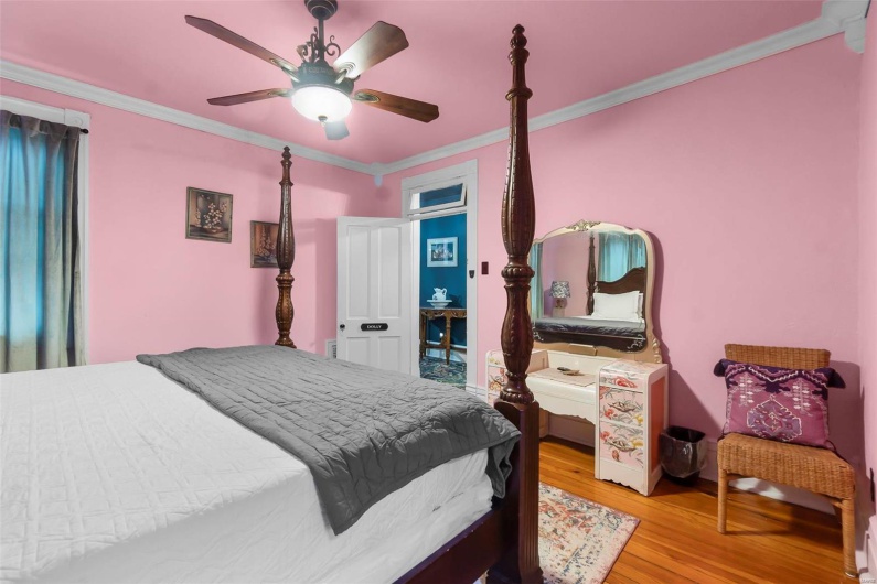 Bedroom with ornamental molding, ceiling fan, and light wood flooring