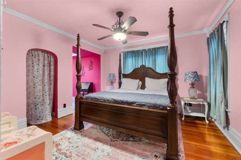 Bedroom featuring ornamental molding, wood flooring, and ceiling fan