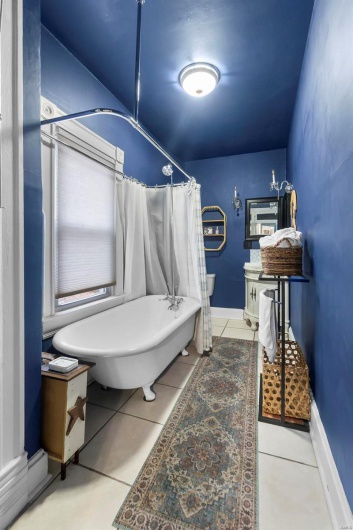 Bathroom featuring a bath and tile patterned flooring