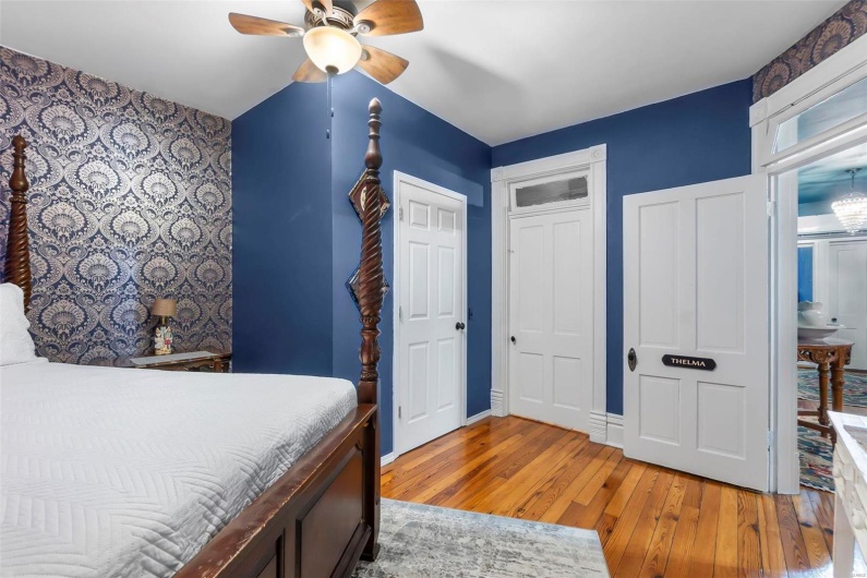 Bedroom with ceiling fan and light hardwood floors