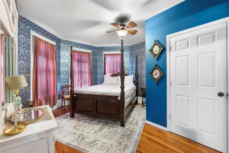 Bedroom with ceiling fan and hardwood floors