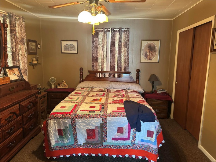Bedroom featuring dark carpet