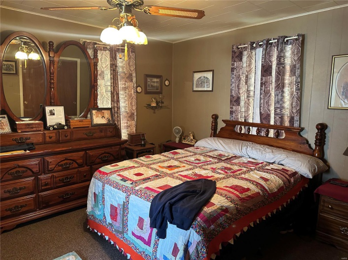 Bedroom with ceiling fan and carpet flooring