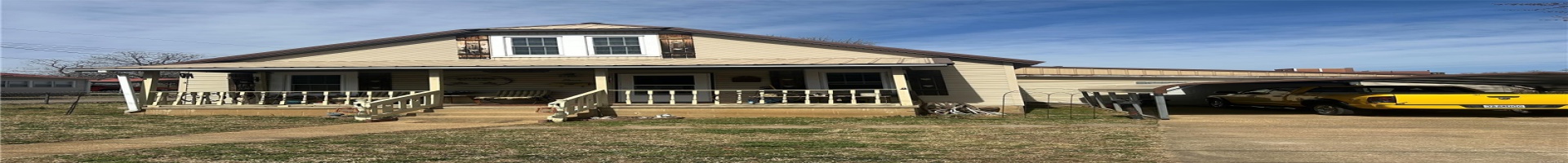 Residential For Sale View of front facade with a detached carport, a porch, driveway, and metal roof