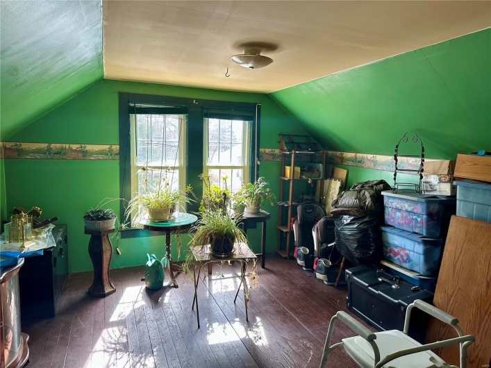 Additional living space with vaulted ceiling and wood finished floors