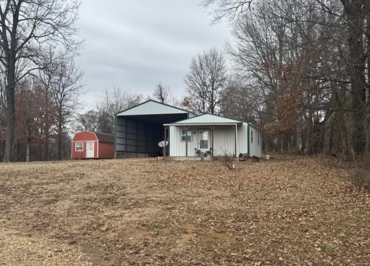 View of shed featuring a carport