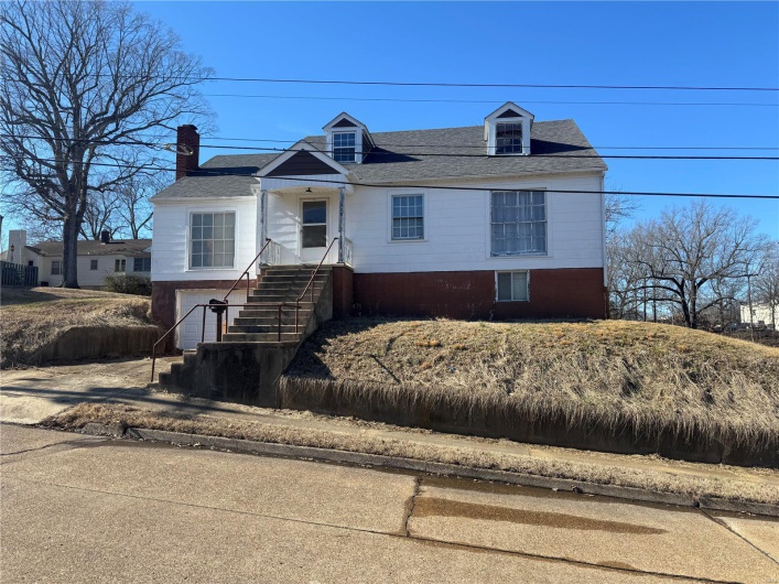 View of front of property featuring roof with shingles and an attached garage