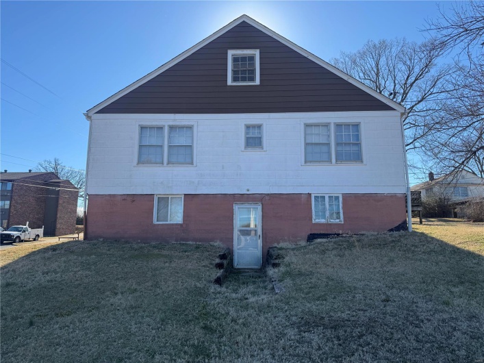 View of side of home featuring a yard