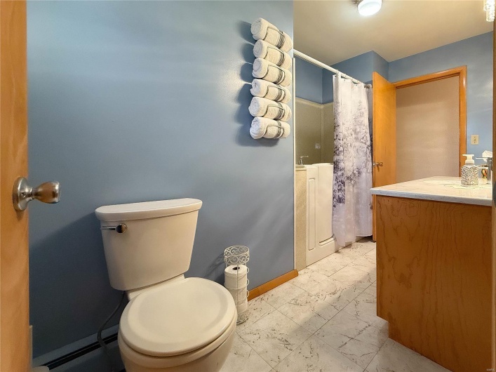 Full bath featuring toilet, vanity, baseboards, marble finish floor, and a shower with curtain
