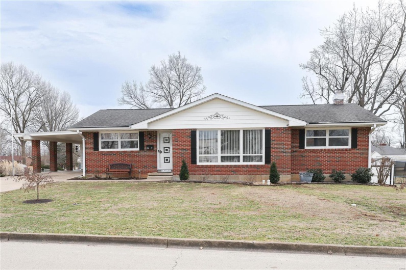 Ranch-style home with roof with shingles, brick siding, a front lawn, and an attached carport