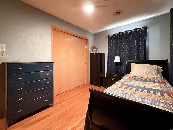 Bedroom featuring a closet, visible vents, and light wood-style floors